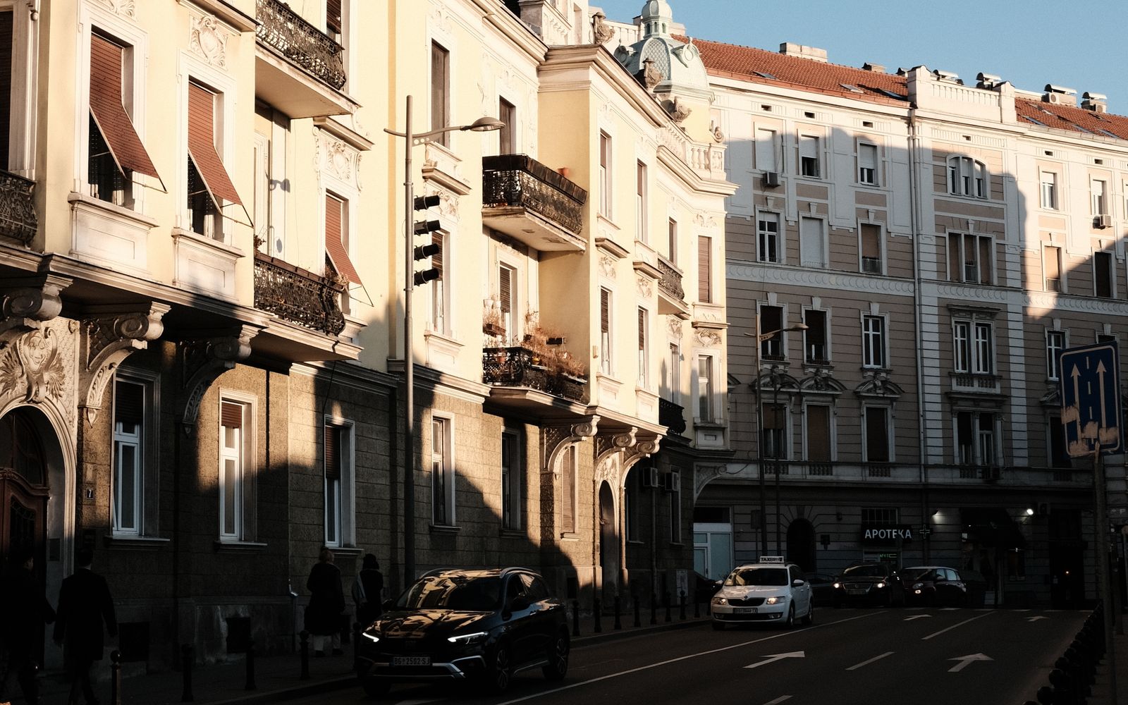 Belgrade street with parked cars and local buildings near Rent a Car M office